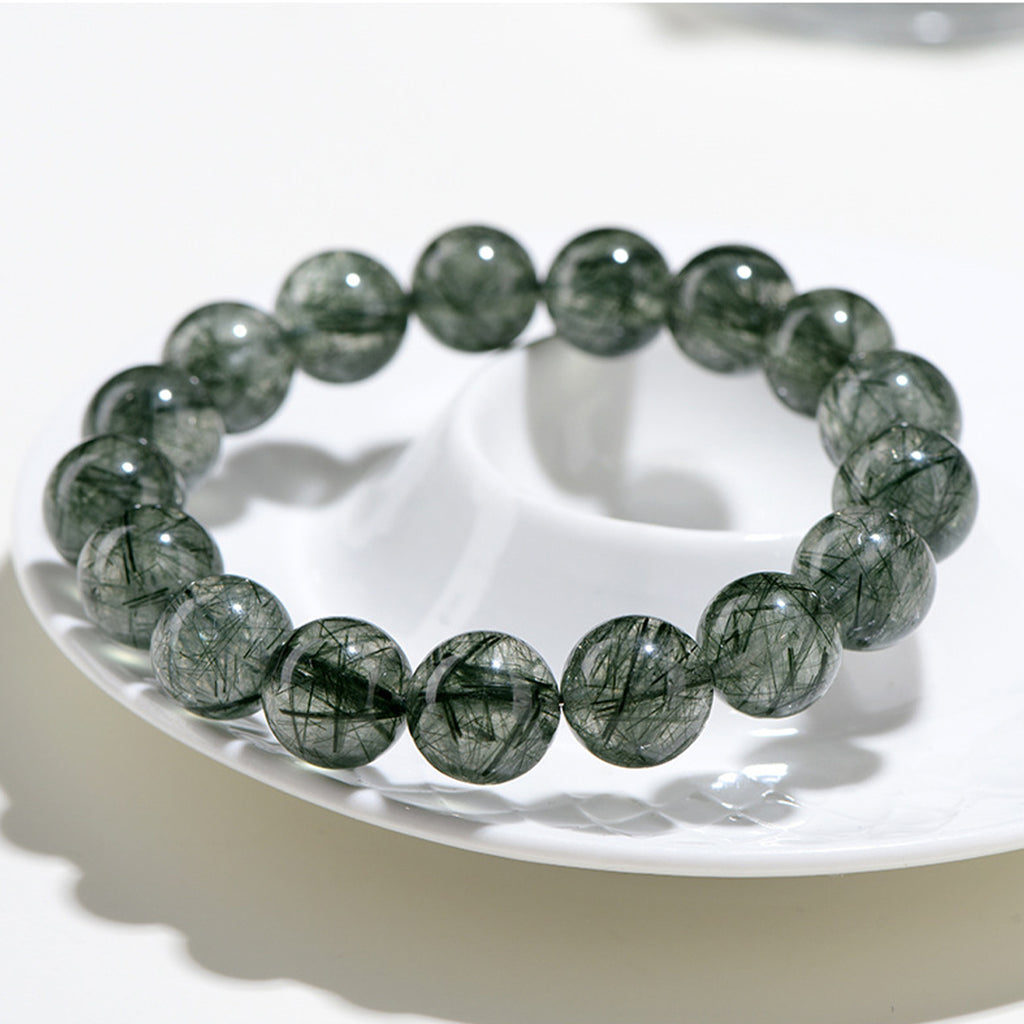 Greenstone beaded bracelet on a white plate