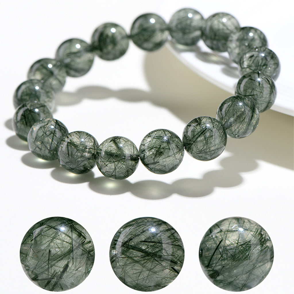 Green gemstone bracelet and loose beads on a white background