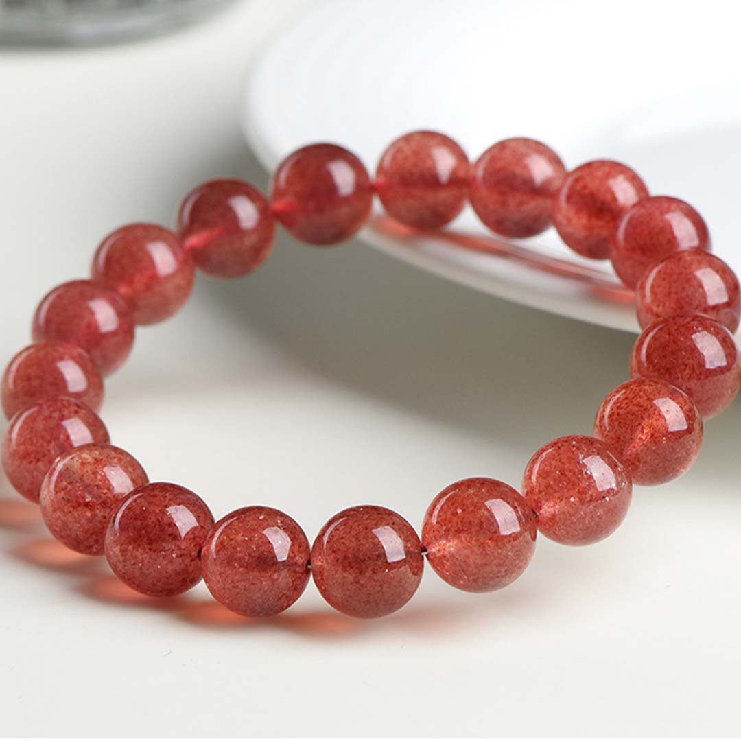 Red beaded bracelet on a white surface