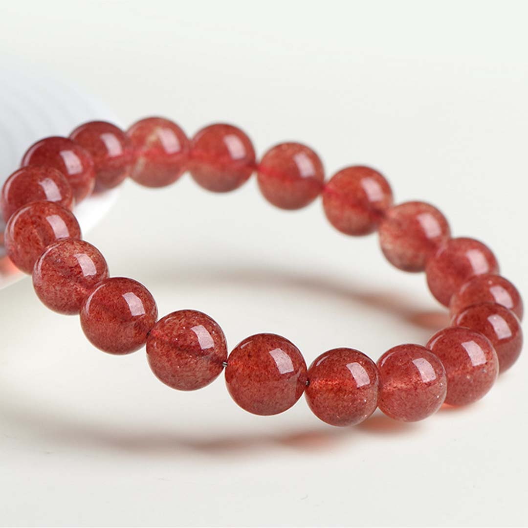 Red beaded bracelet on a white background