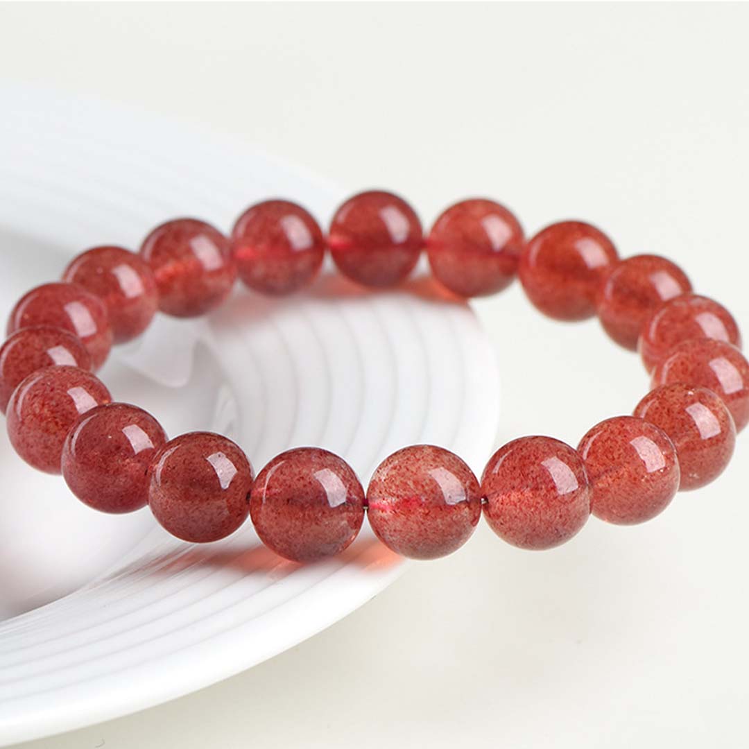 Red beaded bracelet on a white surface