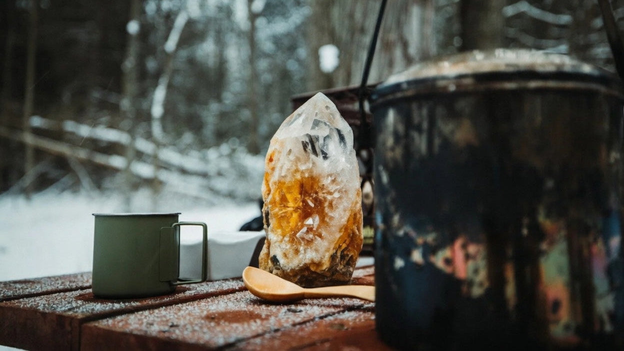 Crystal on a wooden table with a snowy forest background